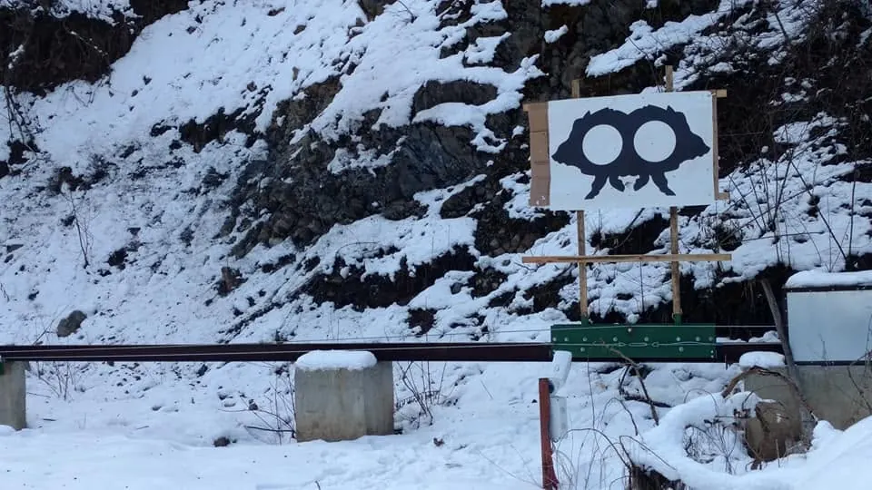 Shooting range with a running target